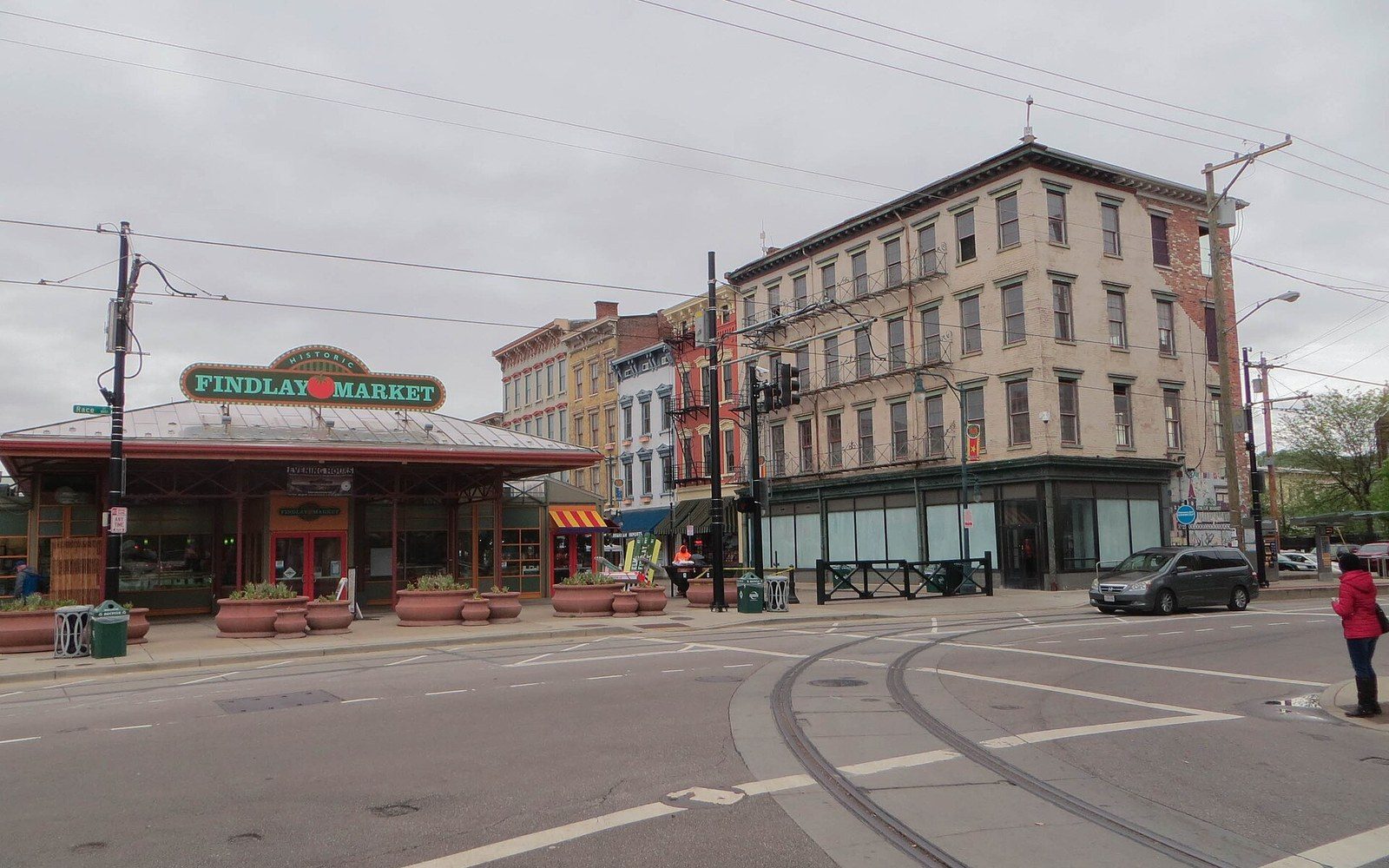 Findlay Market's canopy and sign sit across from historic storefronts on a quiet street corner